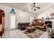 Comfortable living room with tile flooring, a ceiling fan, and a cozy seating area at 6110 E Ivyglen St, Mesa, AZ 85205