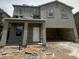 Two-story home featuring stucco facade and a covered entryway, awaiting finishing touches at 1998 E Bucking Bronco Dr, San Tan Valley, AZ 85140