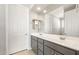 Bathroom featuring double sinks, a large mirror, gray cabinetry, and sleek modern fixtures at 26992 W Melinda Ln, Buckeye, AZ 85396