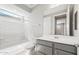 Bathroom featuring a tub-shower combination, sleek vanity, and neutral wall color at 26992 W Melinda Ln, Buckeye, AZ 85396