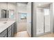 Bright bathroom featuring double sinks, stylish vanity, glass shower, and neutral color palette at 26992 W Melinda Ln, Buckeye, AZ 85396
