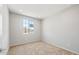 A carpeted room bathed in sunlight from a large window at 26992 W Melinda Ln, Buckeye, AZ 85396