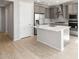 Kitchen featuring stainless steel appliances, gray cabinetry, and light wood flooring at 26992 W Melinda Ln, Buckeye, AZ 85396