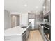 Kitchen featuring stainless steel appliances, gray cabinetry, large center island and light wood flooring at 26992 W Melinda Ln, Buckeye, AZ 85396