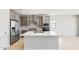 Open concept kitchen featuring stainless steel appliances, large center island, and gray cabinets at 26992 W Melinda Ln, Buckeye, AZ 85396