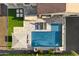 Aerial view of backyard with a pool, outdoor kitchen, dining area, firepit, and artificial grass at 3574 E Tonto Pl, Chandler, AZ 85249