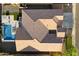 Aerial view of the property showing the roof line, backyard, pool, patio, and surrounding landscape at 3574 E Tonto Pl, Chandler, AZ 85249