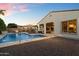 Beautiful backyard view showcasing the pool, firepit, outdoor kitchen, and covered patio for outdoor enjoyment at 3574 E Tonto Pl, Chandler, AZ 85249