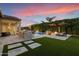 Inviting backyard features a pool, outdoor kitchen, fire pit, and seating area, perfect for entertaining at 3574 E Tonto Pl, Chandler, AZ 85249