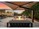 Inviting backyard oasis with pool, fire pit, covered seating, and lush landscaping at 3574 E Tonto Pl, Chandler, AZ 85249