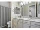 Bathroom vanity featuring double sinks, marble countertop, and modern fixtures at 3574 E Tonto Pl, Chandler, AZ 85249
