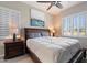 Bedroom featuring a wooden bed frame, shutters, and modern ceiling fan at 3574 E Tonto Pl, Chandler, AZ 85249