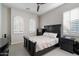 Bedroom featuring a black bed frame, shutters, and modern ceiling fan at 3574 E Tonto Pl, Chandler, AZ 85249