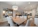 Elegant dining area adjacent to the kitchen, featuring a large window and contemporary lighting fixture at 3574 E Tonto Pl, Chandler, AZ 85249