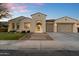 Inviting front exterior featuring an arched entryway, a two-car garage, and green landscaping at 3574 E Tonto Pl, Chandler, AZ 85249