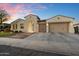 Beautiful home exterior showcasing a brick-accented driveway, a two-car garage, and manicured landscaping at dusk at 3574 E Tonto Pl, Chandler, AZ 85249