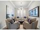 Cozy seating area with modern chandelier, shutters, and tasteful decor at 3574 E Tonto Pl, Chandler, AZ 85249