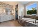 Elegant main bathroom featuring a soaking tub, glass shower, and modern vanity at 3574 E Tonto Pl, Chandler, AZ 85249