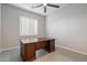 Home office space featuring a wooden desk, tile flooring, and natural light from the window at 3574 E Tonto Pl, Chandler, AZ 85249