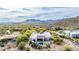 Beautiful aerial view of the home nestled within a desert landscape with mountain views in the distance at 36075 N Summit Dr, Cave Creek, AZ 85331