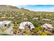 Gorgeous aerial shot of the home with mountain views and surrounding desert community at 36075 N Summit Dr, Cave Creek, AZ 85331