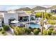 Beautiful backyard with a sparkling pool, spa, lush landscaping, and an outdoor living area at 36075 N Summit Dr, Cave Creek, AZ 85331