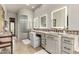 Bathroom with double sinks, vanity space, and a glass block shower at 36075 N Summit Dr, Cave Creek, AZ 85331