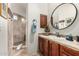 Bathroom with a walk-in shower, wood cabinets, granite countertops, and decorative accents at 36075 N Summit Dr, Cave Creek, AZ 85331