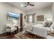 Primary bedroom suite with TV, hardwood floors, and comfortable seating area with bright light at 36075 N Summit Dr, Cave Creek, AZ 85331