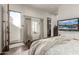 Bright bedroom with a walkout balcony, built-in storage, and stylish hardwood floors at 36075 N Summit Dr, Cave Creek, AZ 85331