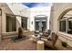 Private courtyard featuring stylish patio furniture, a water feature, and ambient string lighting at 36075 N Summit Dr, Cave Creek, AZ 85331