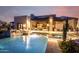 Gorgeous home exterior with a backyard pool, outdoor seating area, and stunning mountain views at twilight at 36075 N Summit Dr, Cave Creek, AZ 85331