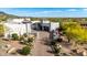 Stunning property showcasing elegant architecture, a paver driveway, and beautifully landscaped desert grounds at 36075 N Summit Dr, Cave Creek, AZ 85331