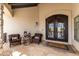 Inviting front porch with seating area and a decorative double door entrance at 36075 N Summit Dr, Cave Creek, AZ 85331