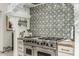 Close up of a kitchen featuring a stainless steel stove and decorative backsplash at 36075 N Summit Dr, Cave Creek, AZ 85331