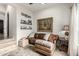 Cozy living room with a leather couch, an ottoman and a beautiful painting on the wall at 36075 N Summit Dr, Cave Creek, AZ 85331