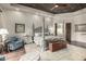 Bedroom suite featuring a four poster bed, accent chair, and dark wood floors at 36075 N Summit Dr, Cave Creek, AZ 85331