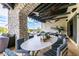 Covered patio featuring a large dining table with comfortable seating and outdoor entertainment area at 36075 N Summit Dr, Cave Creek, AZ 85331