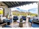 Inviting covered patio with comfortable seating, a serene pool view, and desert mountain backdrop at 36075 N Summit Dr, Cave Creek, AZ 85331