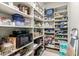 A well-organized walk-in pantry with shelves stocked with various food items and appliances at 36075 N Summit Dr, Cave Creek, AZ 85331