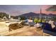 Luxurious outdoor living space featuring a pool, comfortable lounge furniture, and stunning mountain views at 36075 N Summit Dr, Cave Creek, AZ 85331