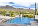 Beautiful backyard pool with mountain views, featuring a spa, waterfall features and desert landscaping at 36075 N Summit Dr, Cave Creek, AZ 85331