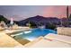 Picturesque backyard pool area with lounge seating, an outdoor kitchen and mountain views at 36075 N Summit Dr, Cave Creek, AZ 85331