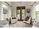 Bright sitting area with doors to the outside features two white swivel chairs at 36075 N Summit Dr, Cave Creek, AZ 85331