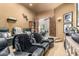 Home theater featuring tiered leather seating, wall sconces, and an entrance with double wooden doors at 36075 N Summit Dr, Cave Creek, AZ 85331