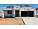 New home's exterior showing the initial stages of construction with scaffolding, roofing tiles, and wrapped insulation at 5064 E Midnight Star Dr, San Tan Valley, AZ 85143