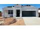 Charming single-story home with a two-car garage, a modern design, and tile roofing in progress at 5064 E Midnight Star Dr, San Tan Valley, AZ 85143