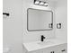 Modern bathroom with a framed mirror, black hardware, and sleek vanity at 5756 N 78Th Pl, Scottsdale, AZ 85250