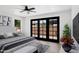 Bedroom featuring a ceiling fan and access to the outdoor patio through sliding glass doors at 5756 N 78Th Pl, Scottsdale, AZ 85250