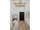 Inviting entryway with wood floors, a dark wood front door, and bright white walls, with a chandelier at 5756 N 78Th Pl, Scottsdale, AZ 85250